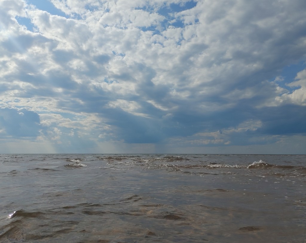 This is a photograph of a storm in the distance on the waters of the Northumberland Strait off Prince Edward Island.